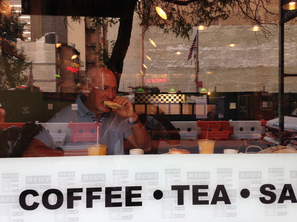 Jean Michel in News eating his first bagel