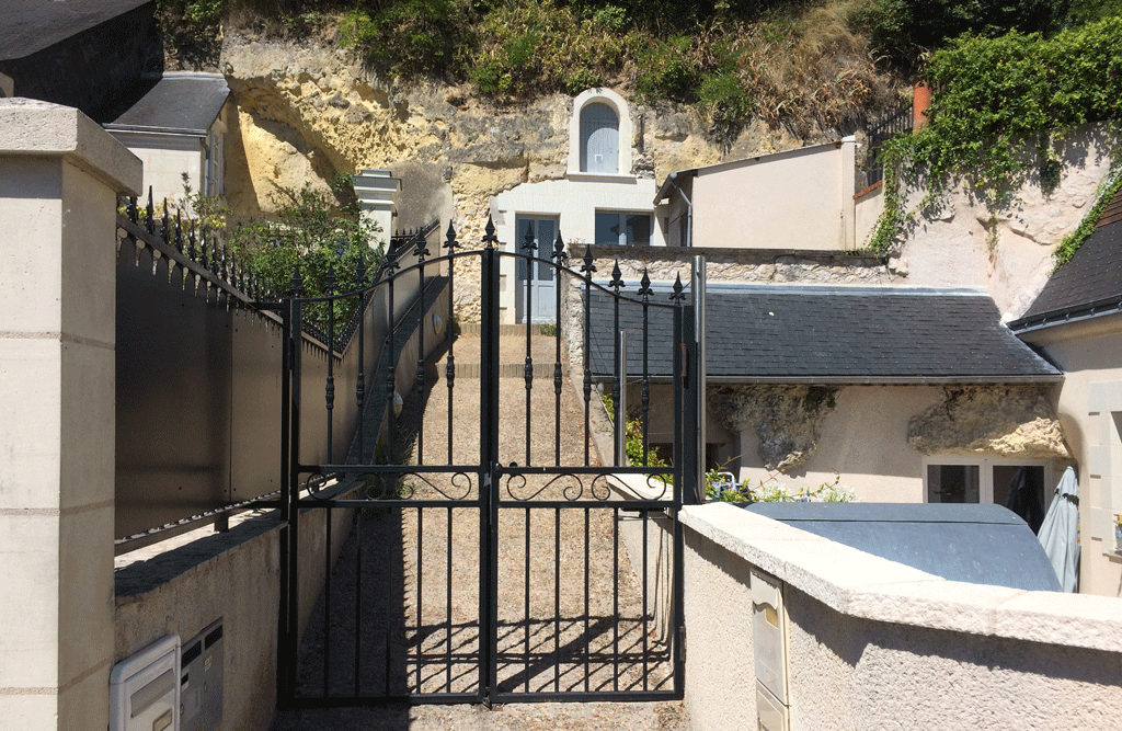 Troglodyte house with blue doors and shutters