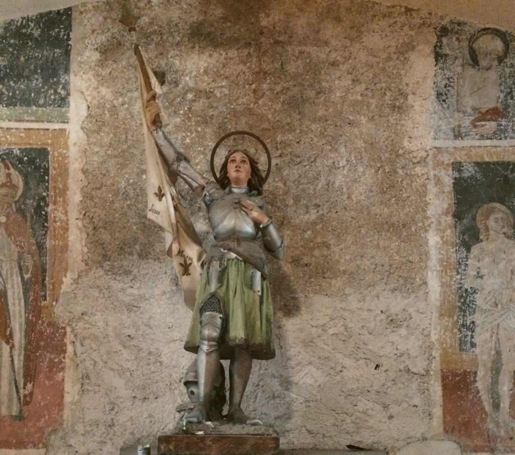 Joan of Arc with a backdrop of frescoes