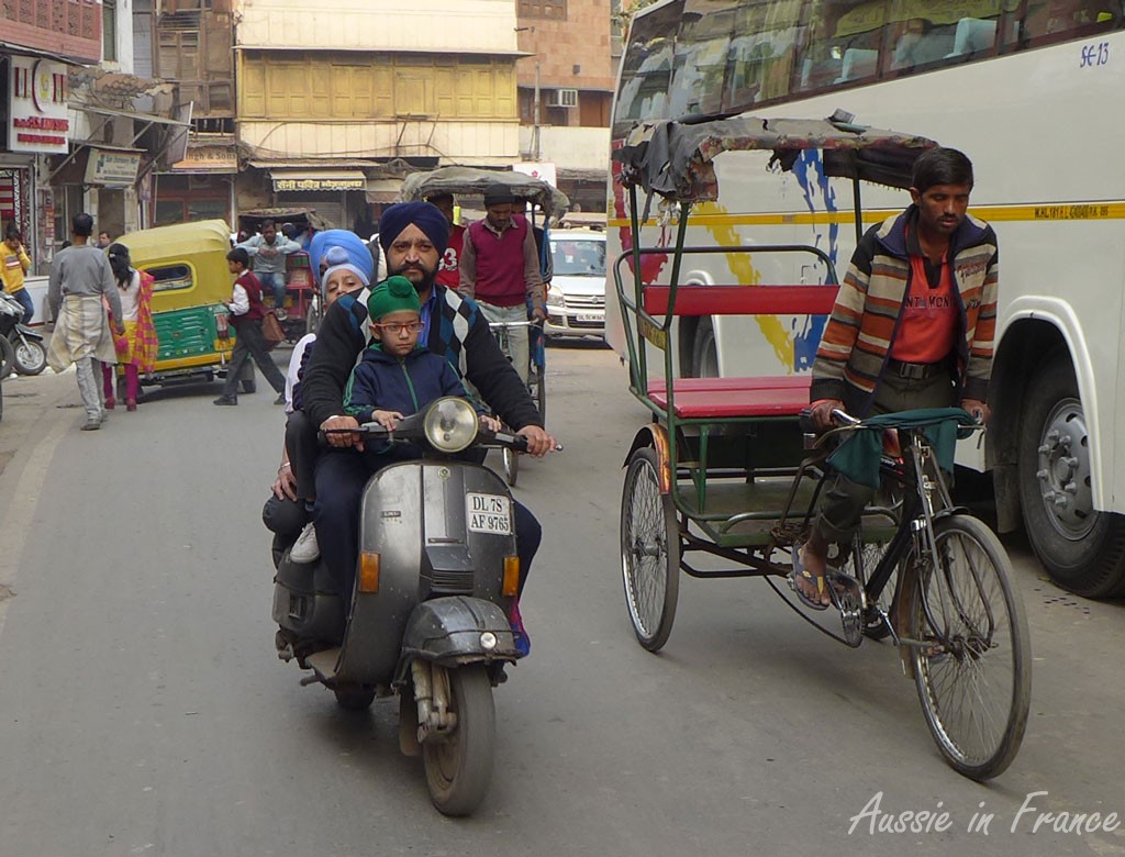 The "family scooter" - you can just see the second child peeking out behind his father