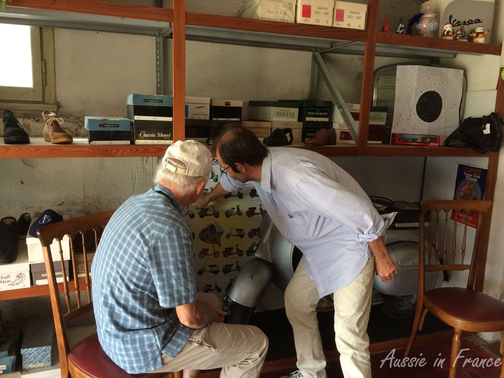 Jean Michel and the bootmaker discussing Vespas