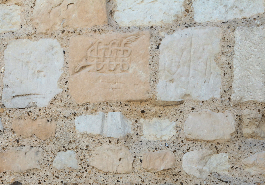 A curious sculpture of a snake on one of the façade stones of the church