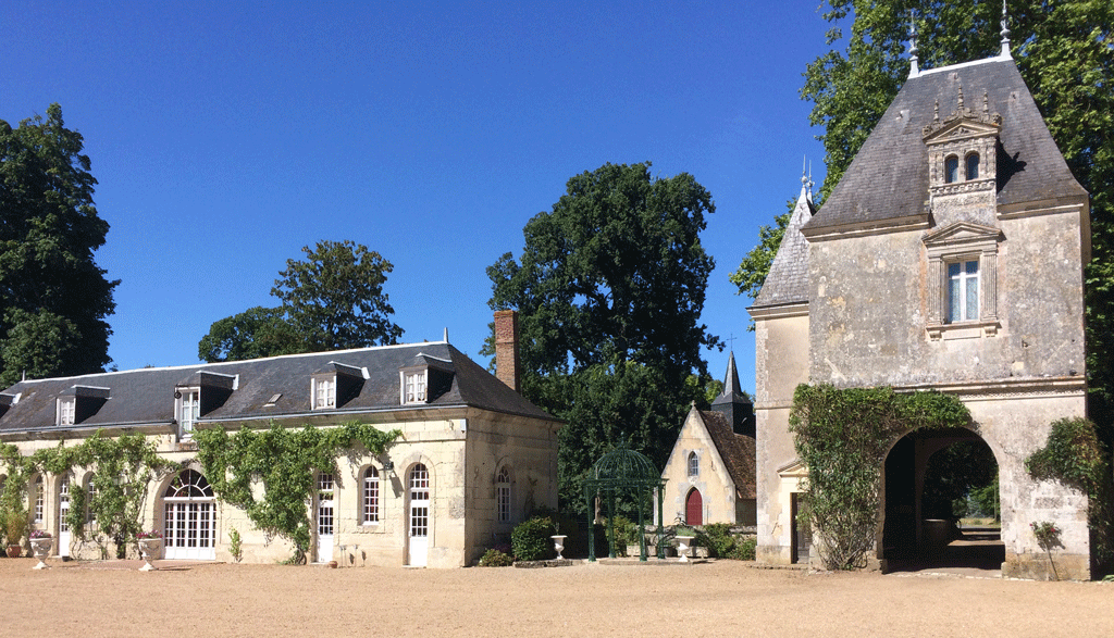 Château de Mézière from inside the courtyard. You can see the Orangery on the left, with the church in the middle and porch on the right.