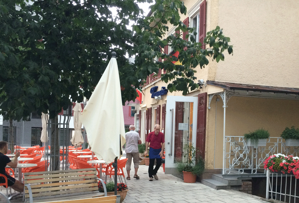 The owner of the eis cafe quic;klky putting down the parasols