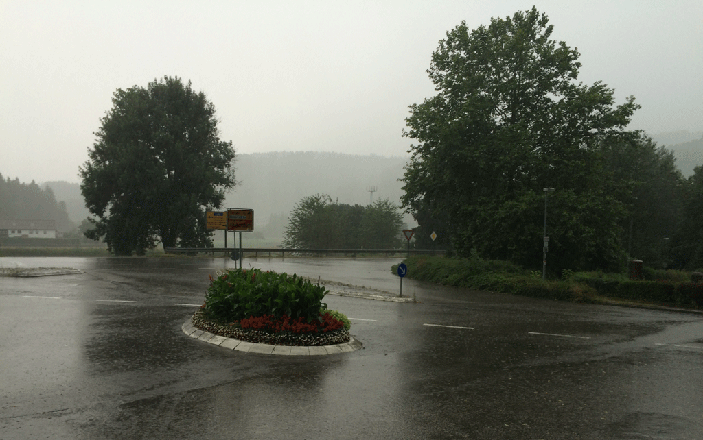 The rain pelting down while I am in the bus shelter