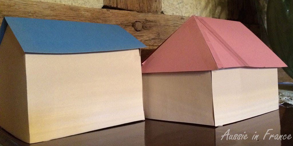The barn on the left and the back of the little house on the right, with its new roof