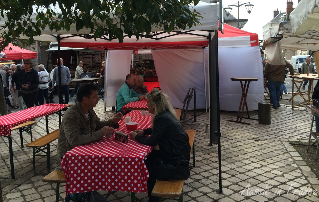 The make-shift coffee tables behind the stall, also red and white.