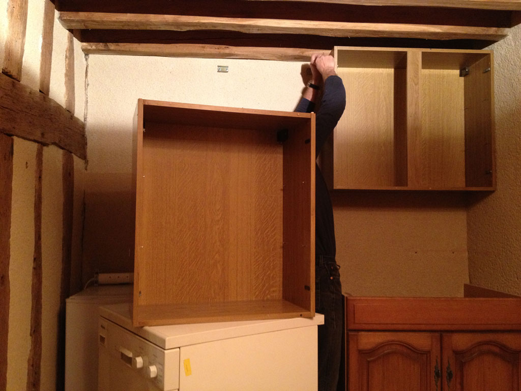Jean Michel putting the cupboards up