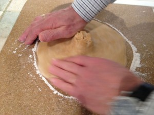 Forming a circle from the ball of dough