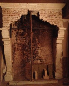 Back of the fireplace with chicken wire over a very uneven surface