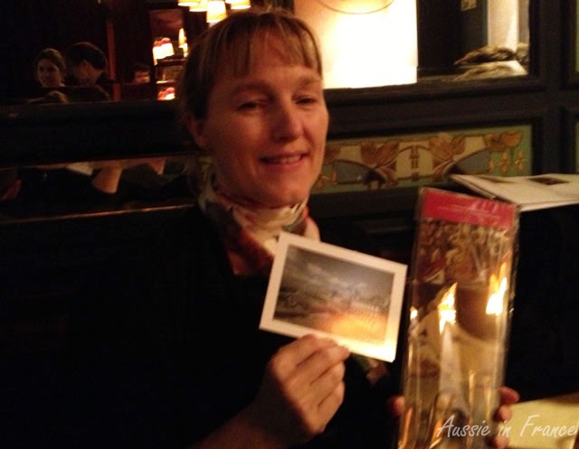 Amanda showing our first prize: a set of Louvre coasters and a postcard of the Louvre each