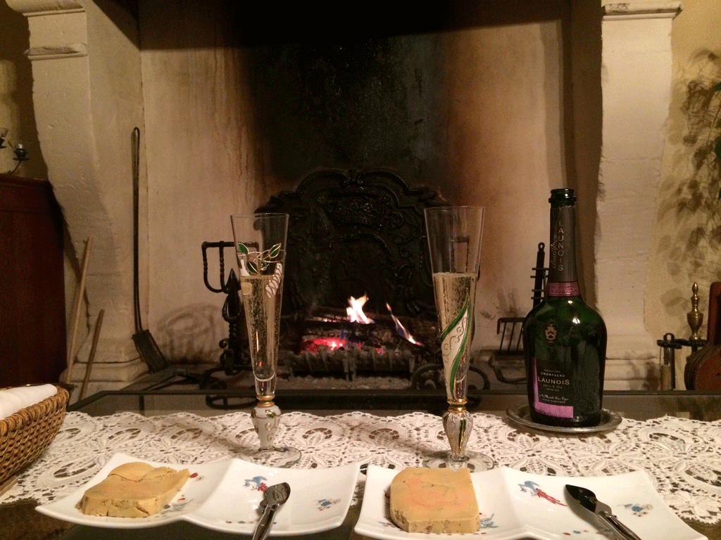 Homemade foie gras and champagne in front of the 400-year old fireplace