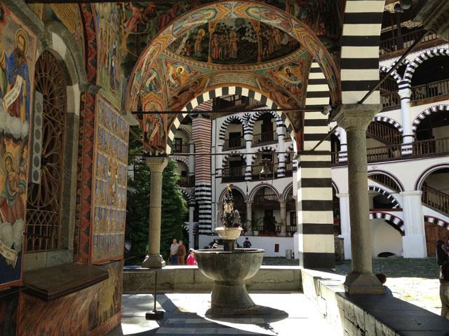 The fountain and frescoes on the church