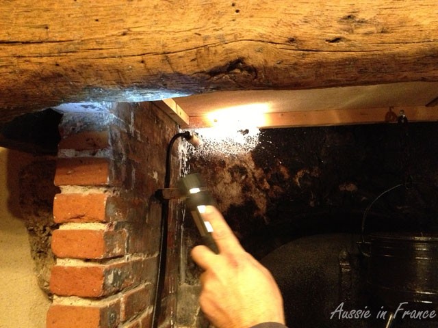 The hole in the corner of the fireplace through which the hornets were passing