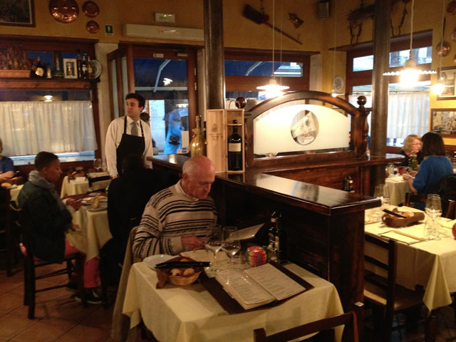 Jean Michel examining the menu at Hosteria al Vecio Bragosso