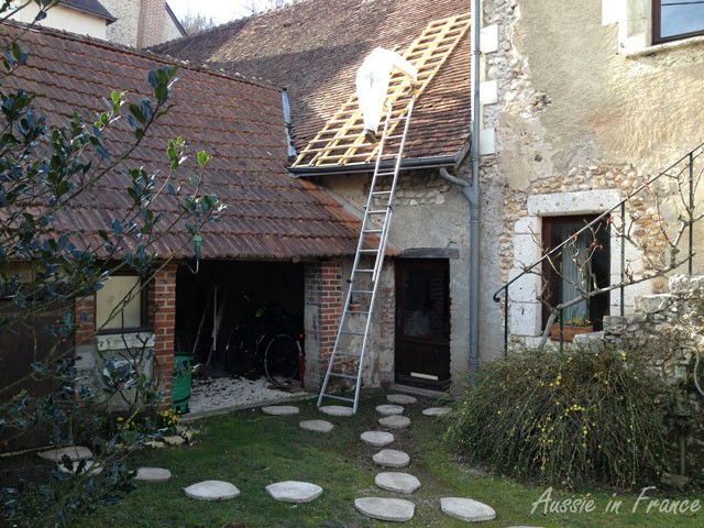 Jean Michel cleaning the moss. Our new paving stones are waiting to be made flush with the ground.