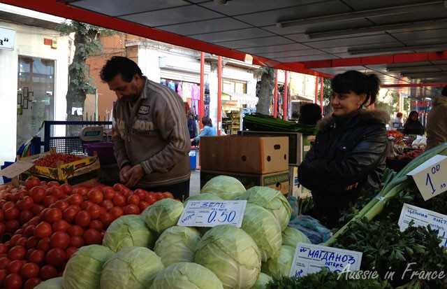 Ladies' market where two vendors shall a stall, each selling two types of vegetables.