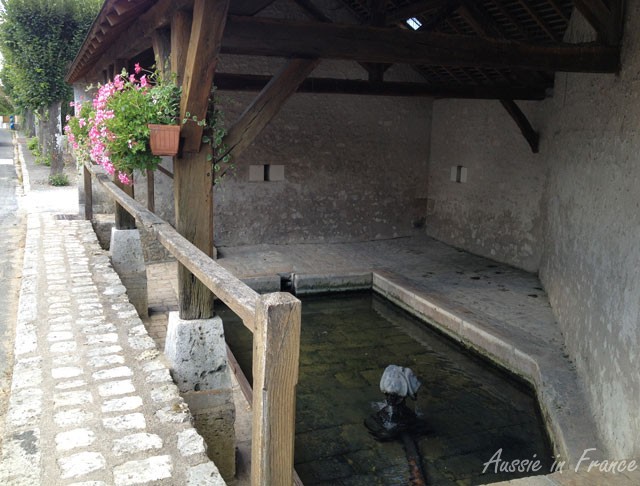 A lavoir with an interesting fountain head in Valliers les Grandes