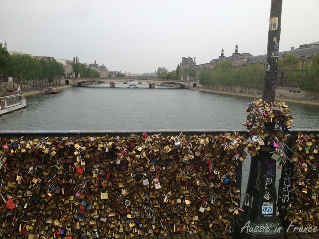 Ponts des Arts weighted down with lovelocks now crawling up the lamp posts