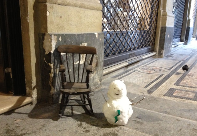 A miniature snowman in front of Miss Bibi's