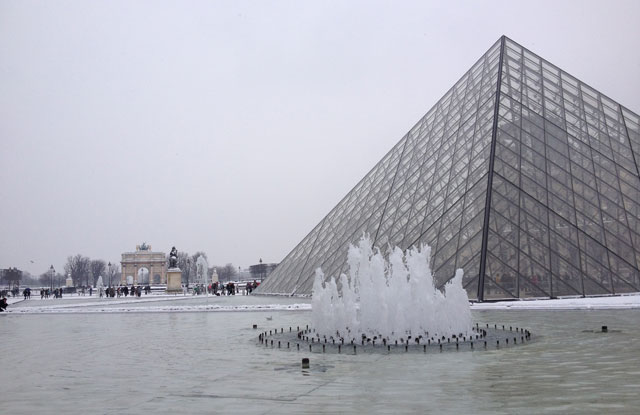 The Louvre pyramid with the water iced over