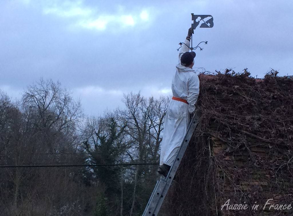 Jean Michel removing the broken weather vane