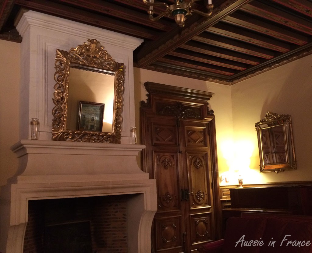 The living room with its carved doors and painted ceiling