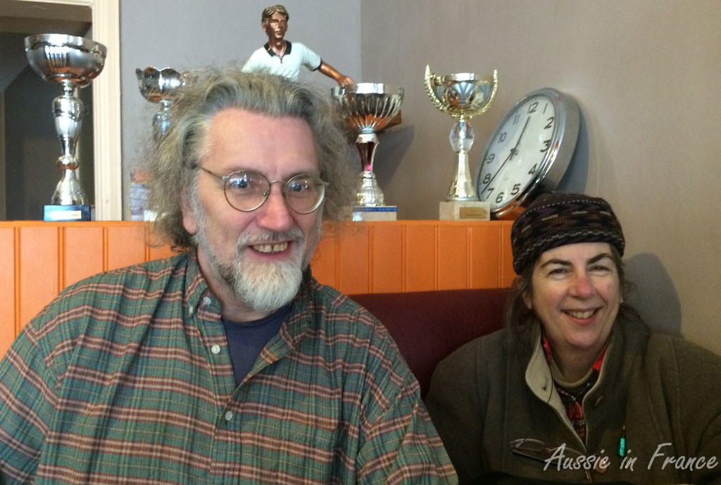 Simon and Susan in front of the soccer trophies