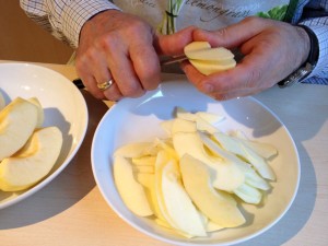 Cutting up apple into thin slices