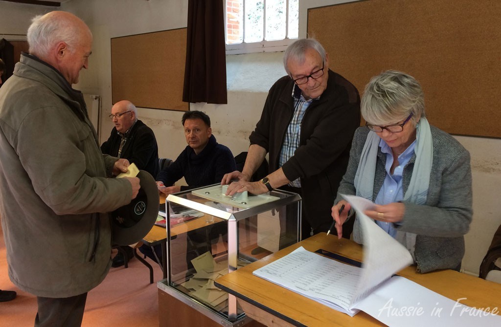 Jean Michel about to but his ballot in the urn