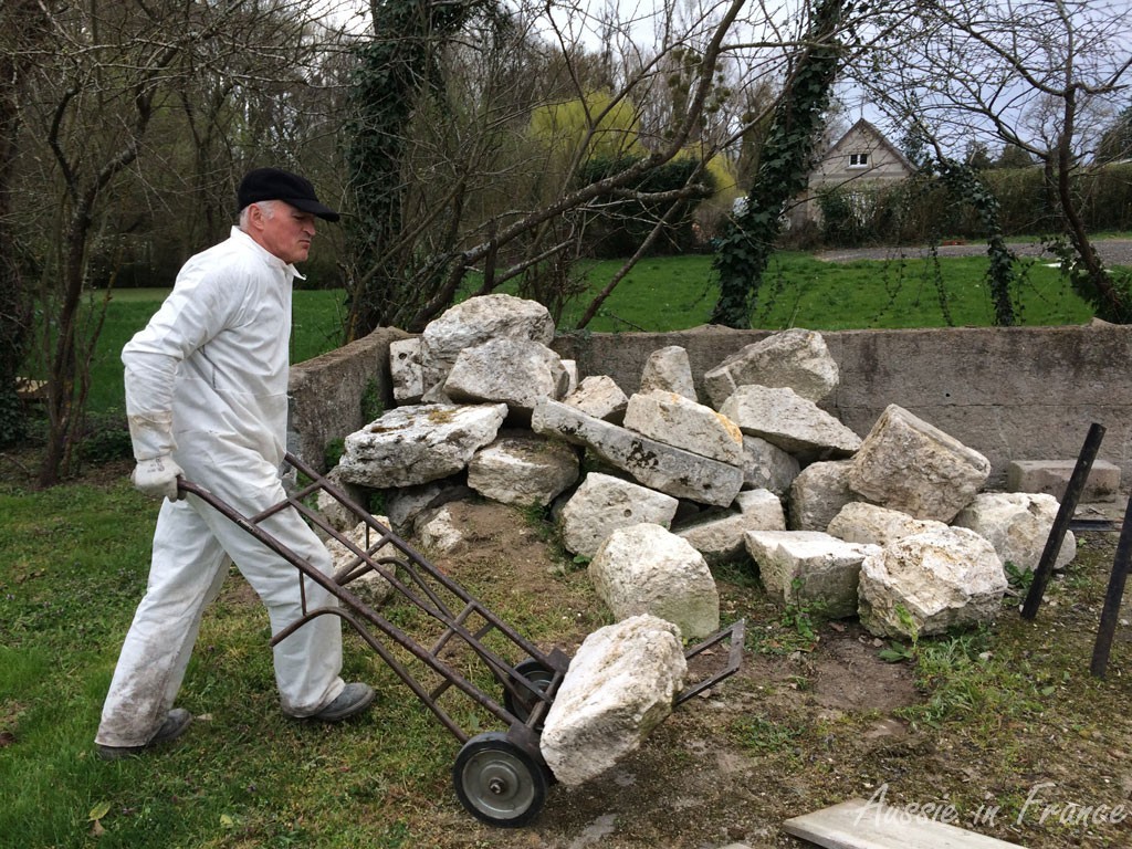 Jean Michel wheeling the stones on the trolley