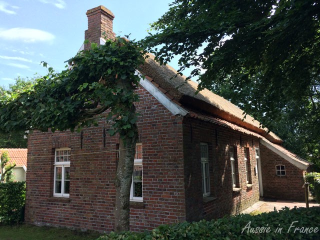 Thatched-roof brick cottage