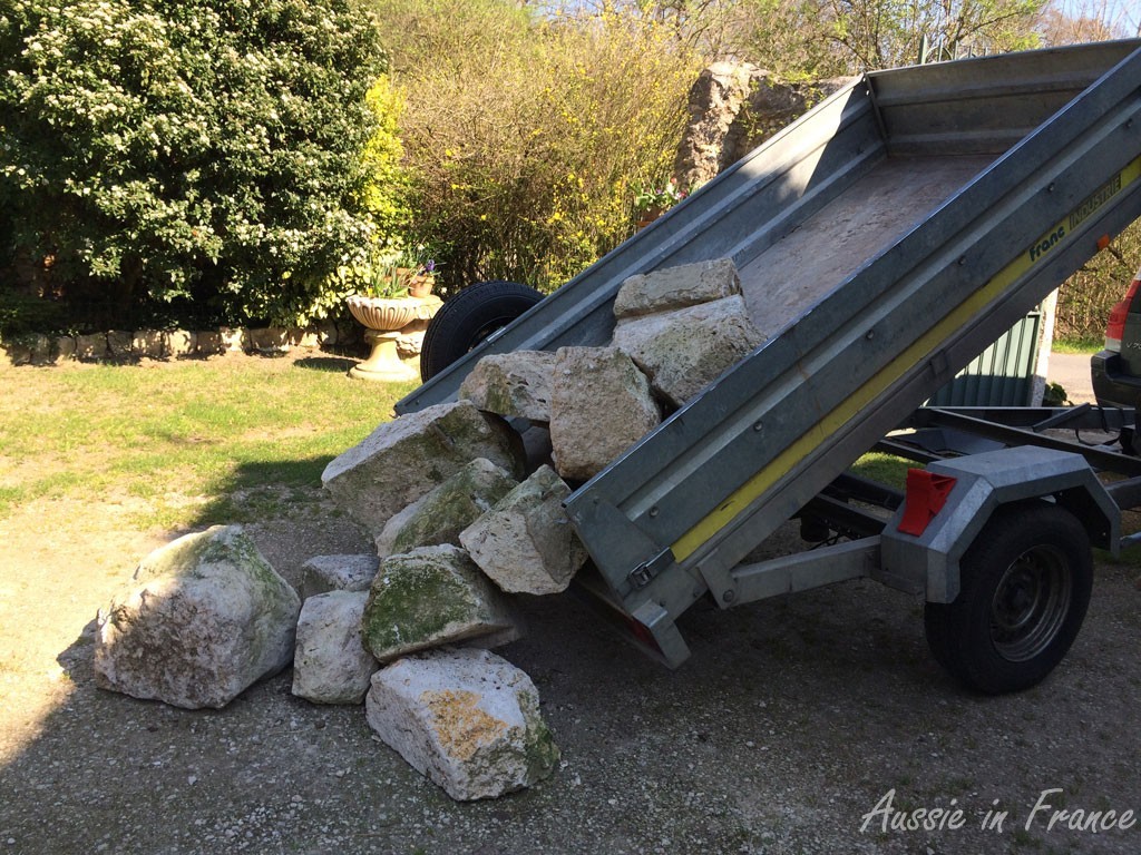 Tipping the stones from the trailer onto the ground at home